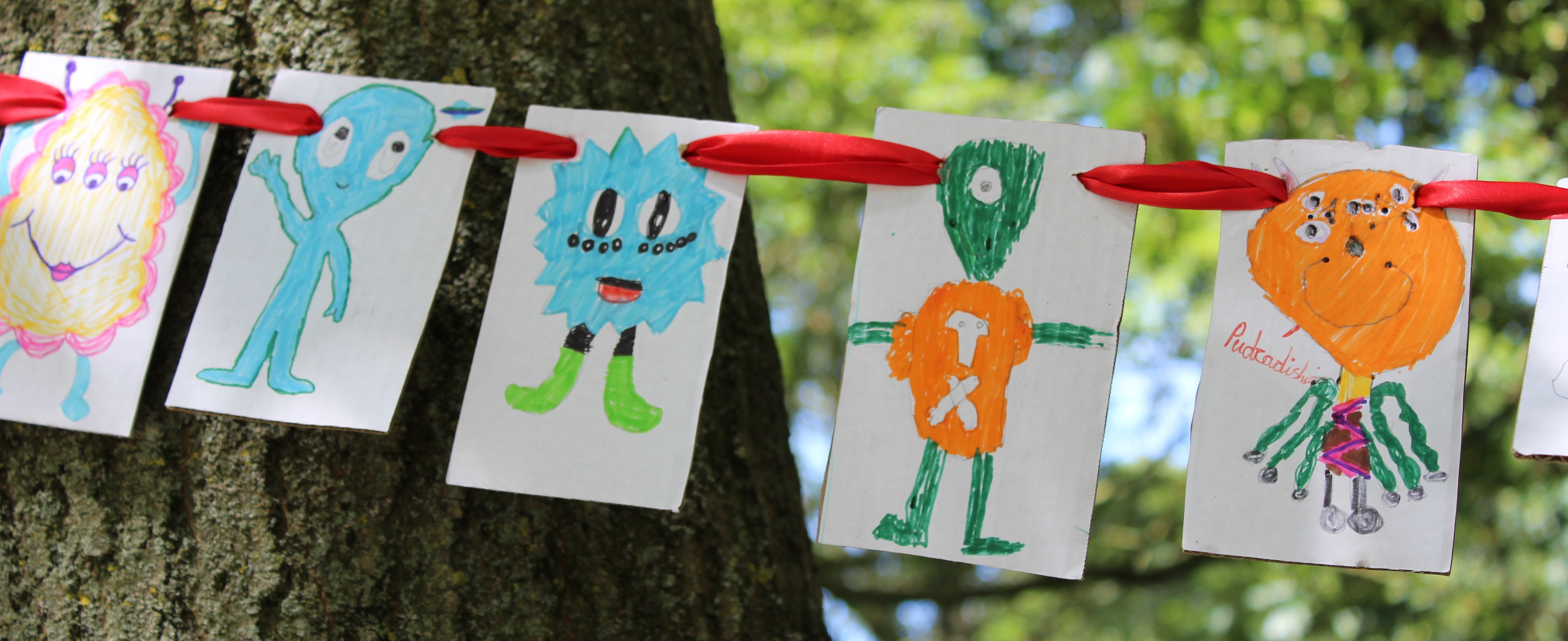 group of alien pictures hanging on a string