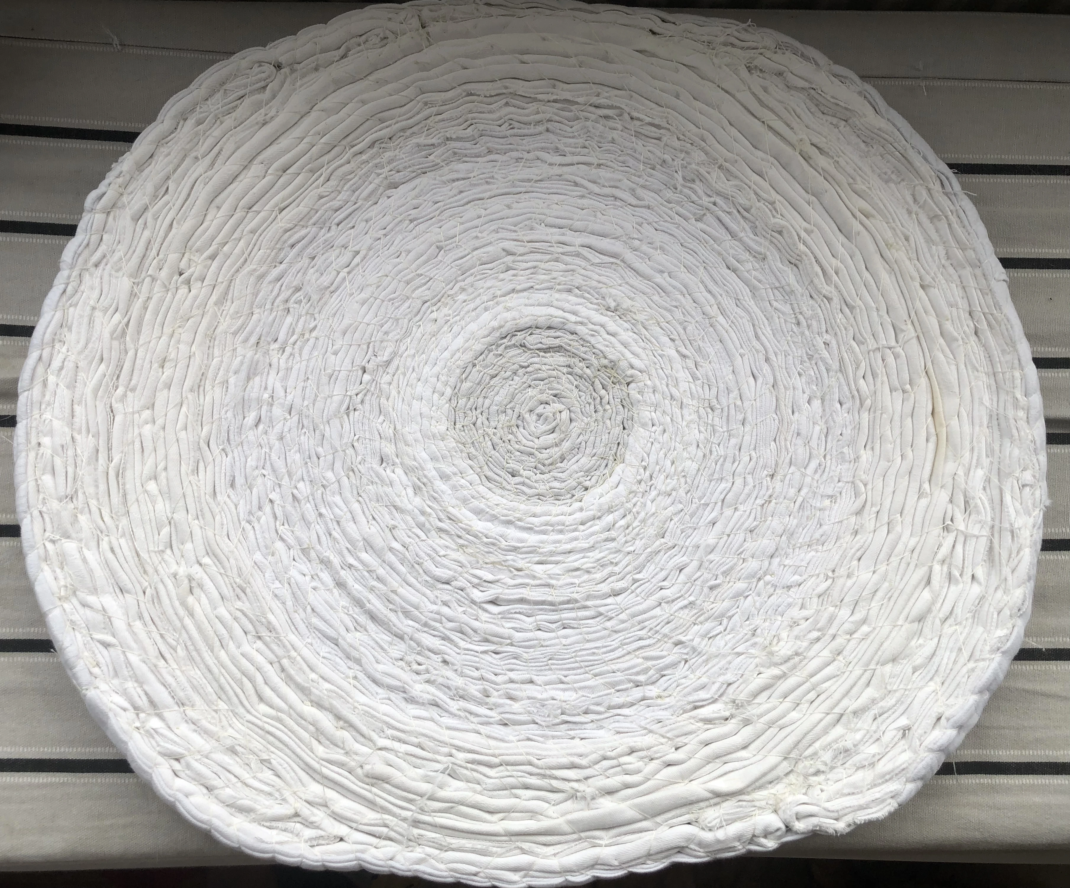 circle formed from coiled strips of white cloth