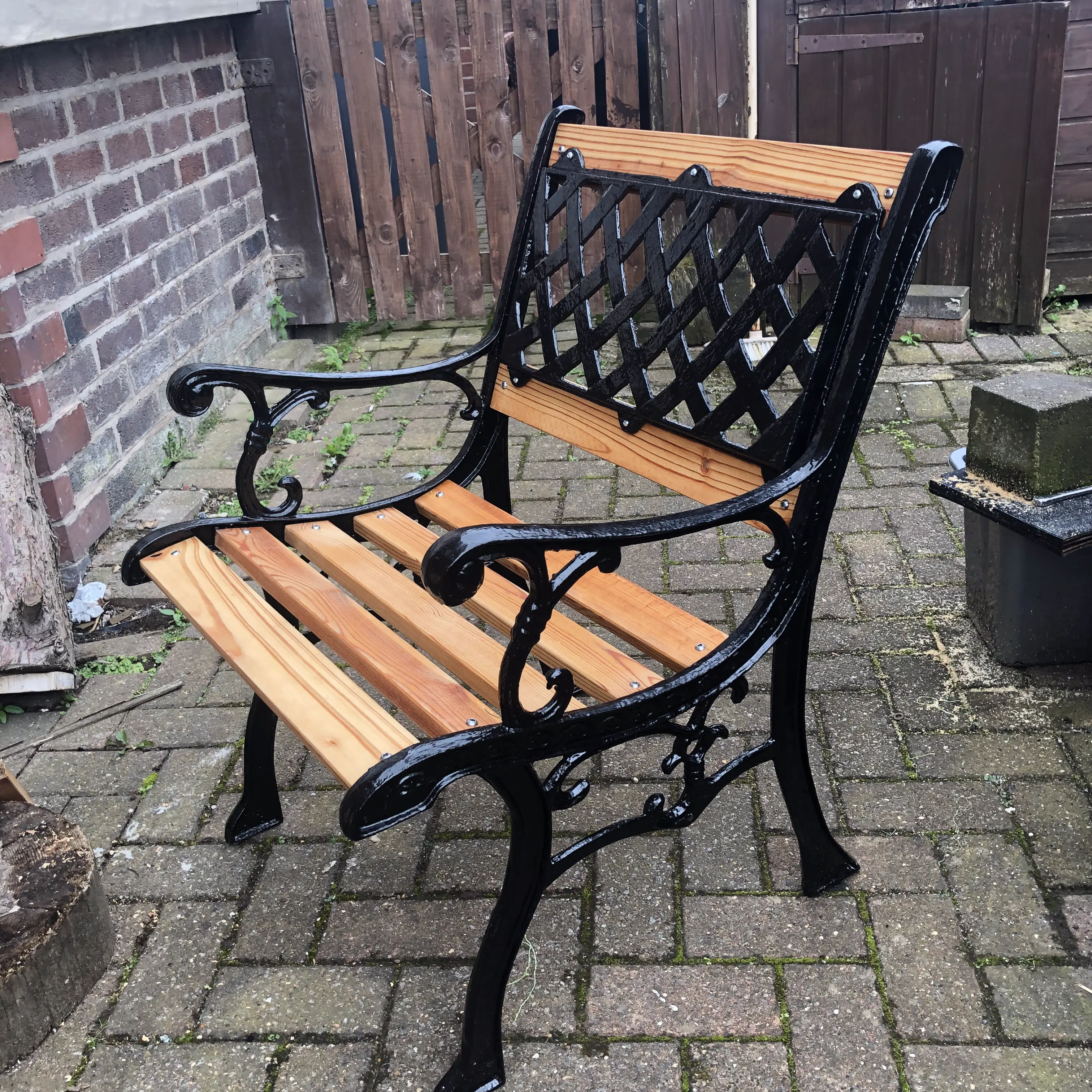 Garden chair with black painted metal sides and back, with oiled pine wooden seat