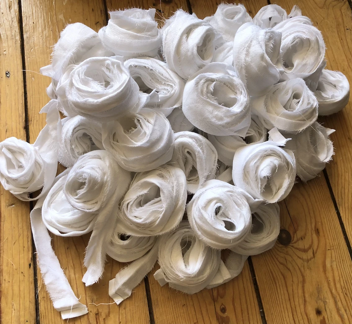 a pile of loosely rolled strips of white fabric