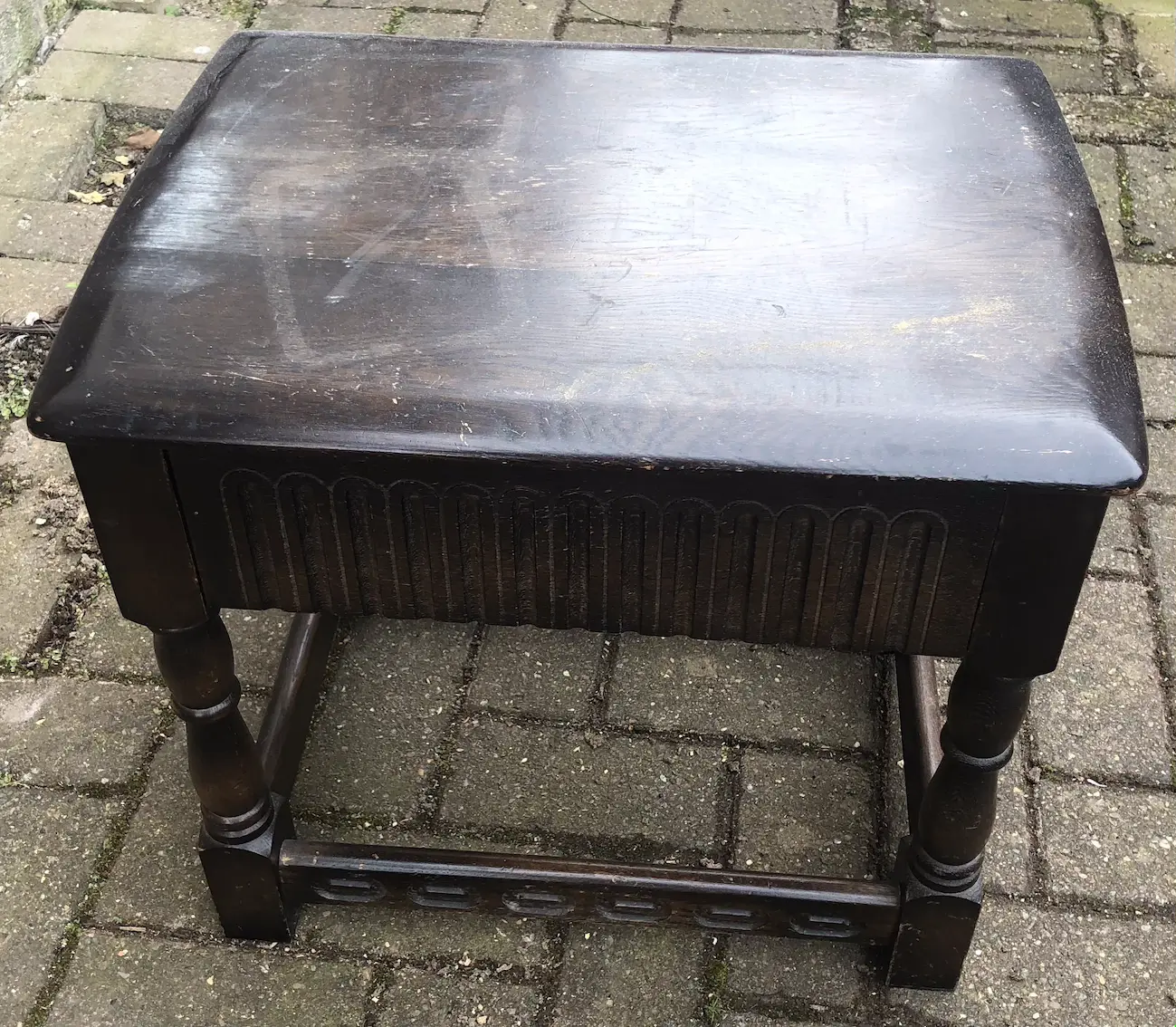 small dark brown table, with carved decoration, viewed from above