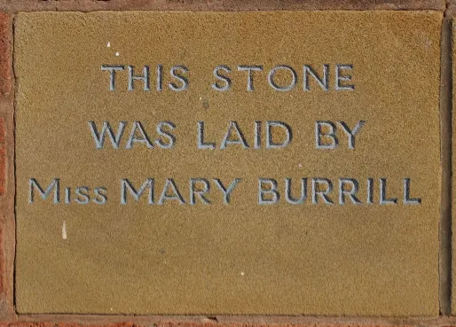 Sandstone memorial stone inscribed 'This stone was laid by Miss Mary Burrill'