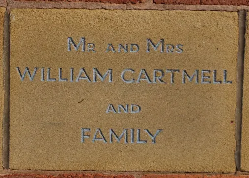 Sandstone memorial stone inscribed 'Mr and Mrs William Cartmell and family'