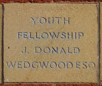 Sandstone memorial stone inscribed 'Youth Fellowship J Donald Wedgwood'