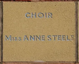 Sandstone memorial stone inscribed 'Choir Miss Anne Steele'