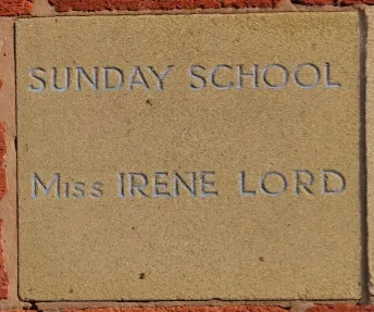 Sandstone memorial stone inscribed 'Sunday School Miss Irene Lord'