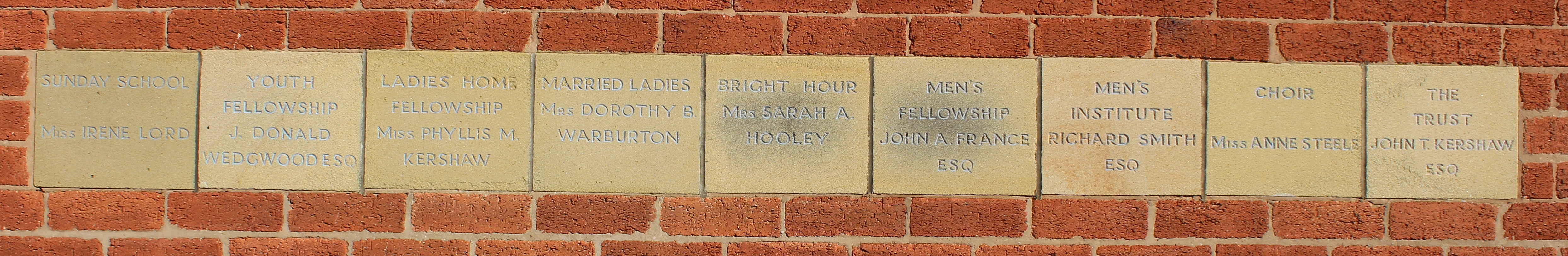 Nine memorial stones set in brickwork of Highfield Methodist Church Hall