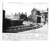 Black and white cutting showing a street view of a church and shops, descriptive text beneath