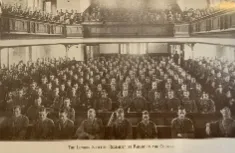 Black and white image of the interior of a church with a balcony, with all seating filled by First World War soldiers