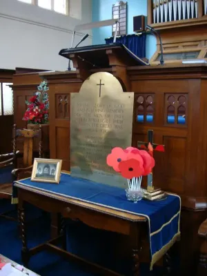 Refurbished First World War brass memorial plaque on a table covered in a blue cloth in Highfield Road Methodist Church